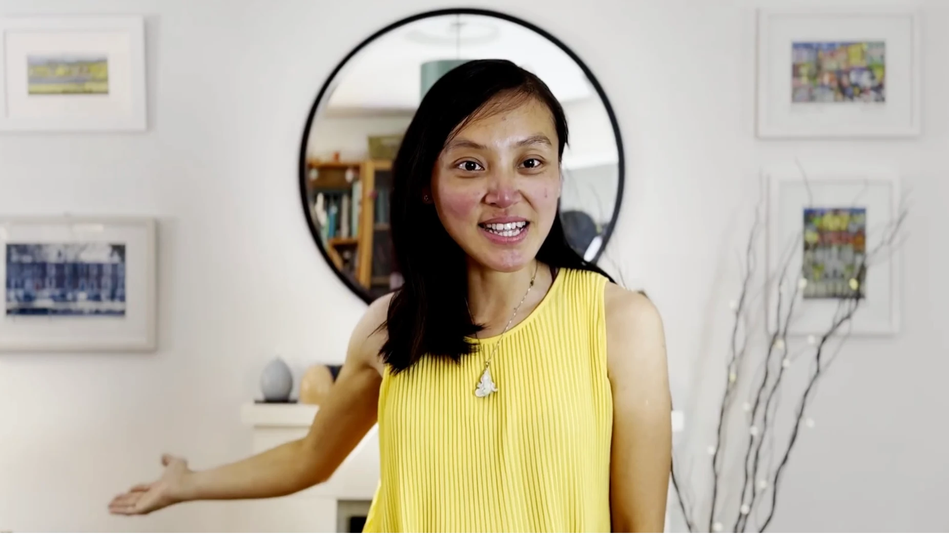 A woman in yellow gestures during an interview