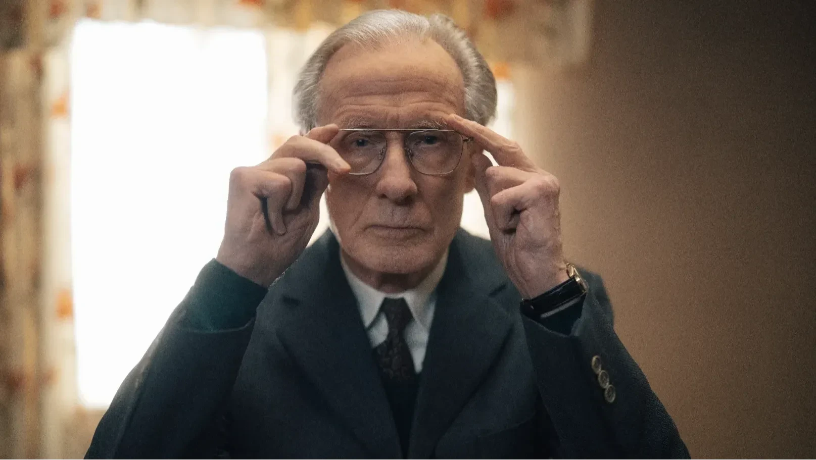 Bill Nighy adjusting his glasses, close-up