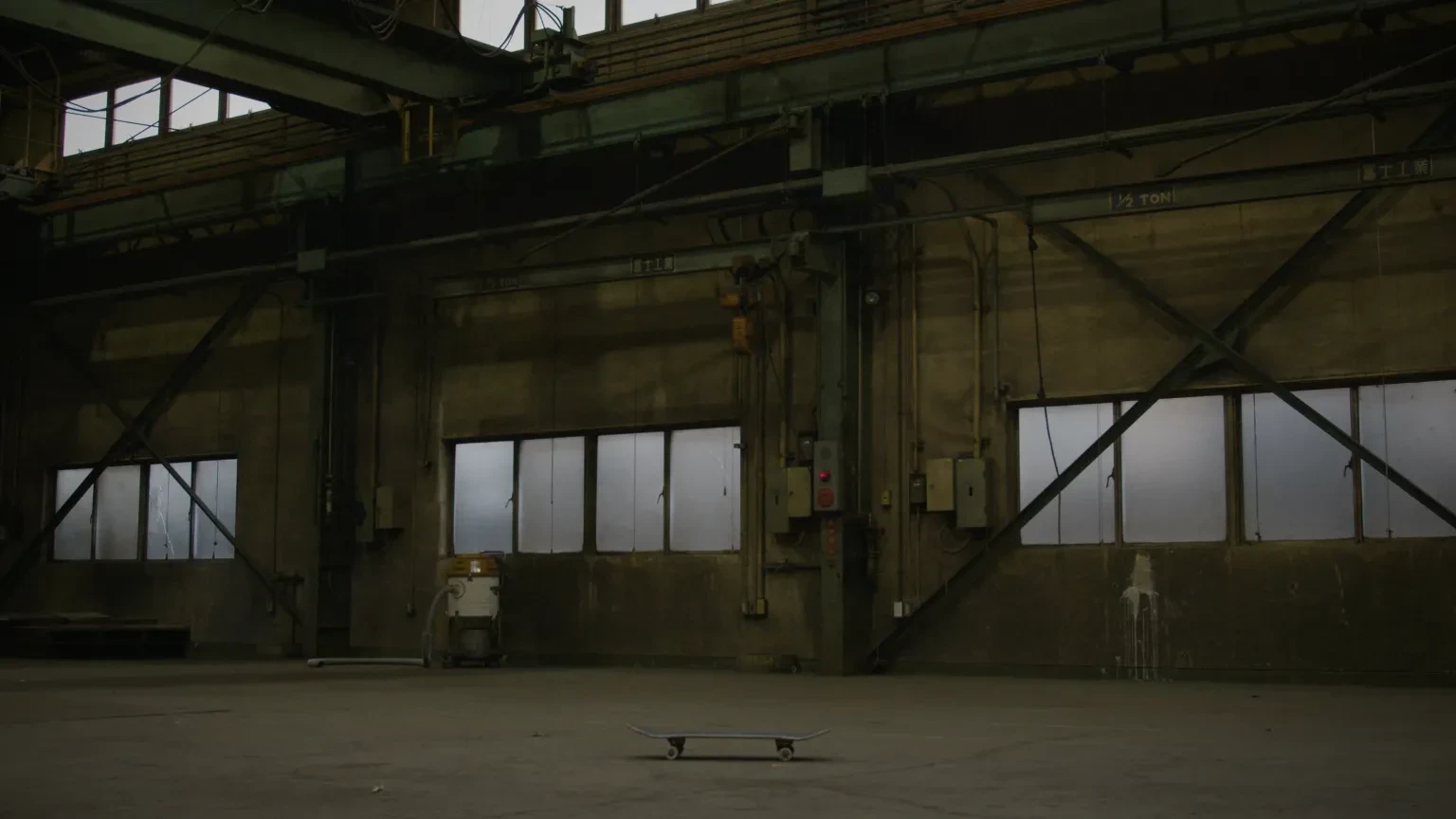 An upturned skateboard in a warehouse