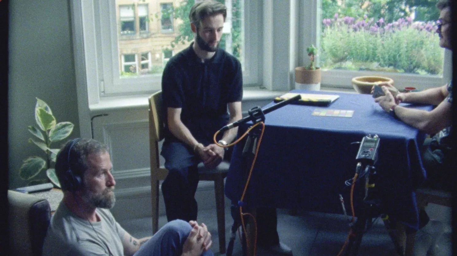 A group of sound technicians listen to sound play back of an interview with Simon Eilbeck