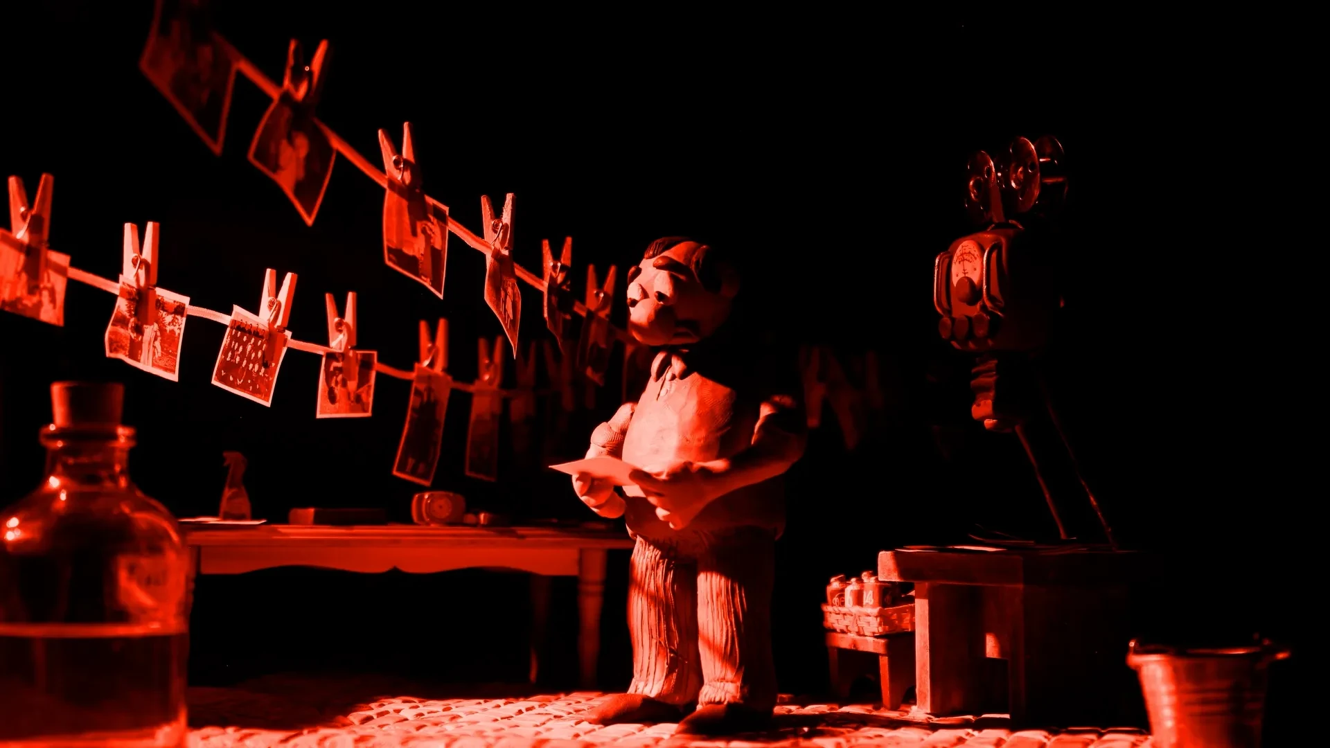 The shopkeeper is fascinated by the photograph of the jungle he just developed