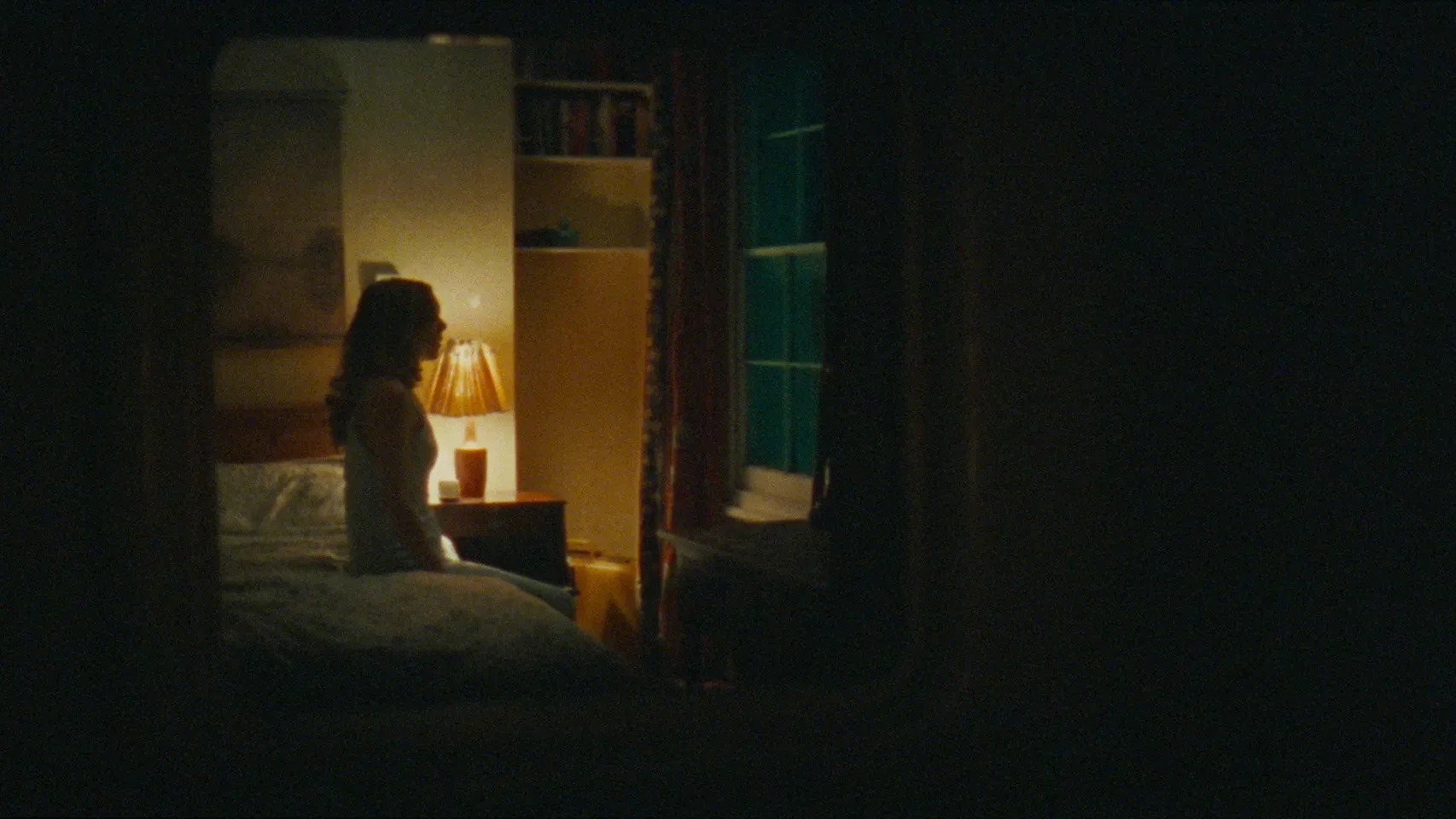 A woman sitting in a dark room