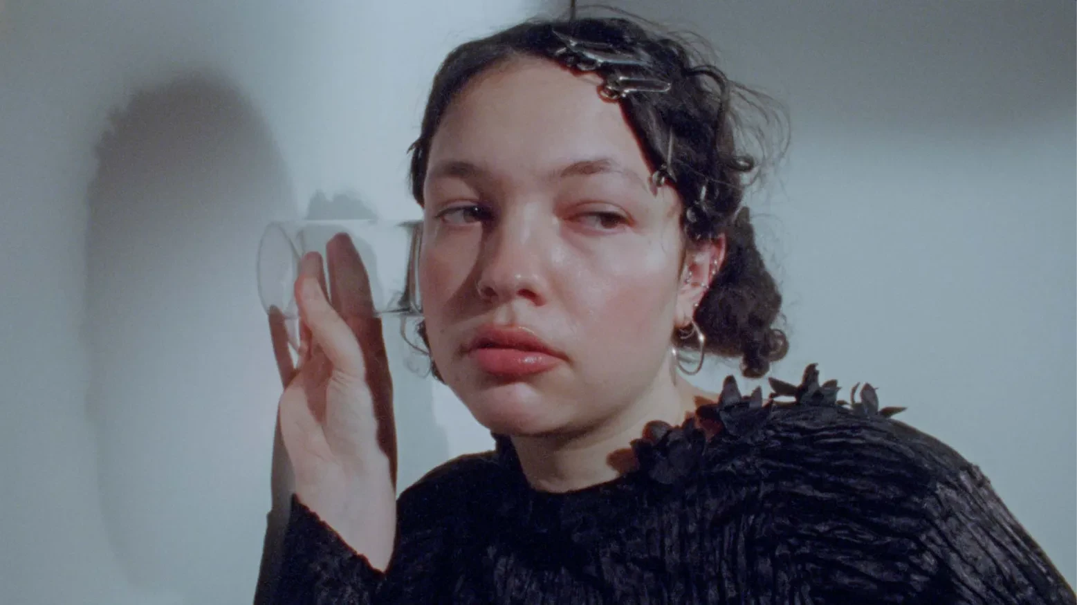 Luce, listening with a glass against the wall