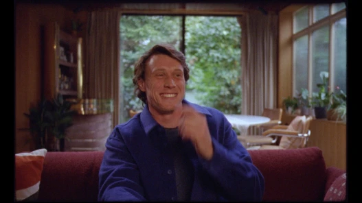George MacKay as Miles laughing