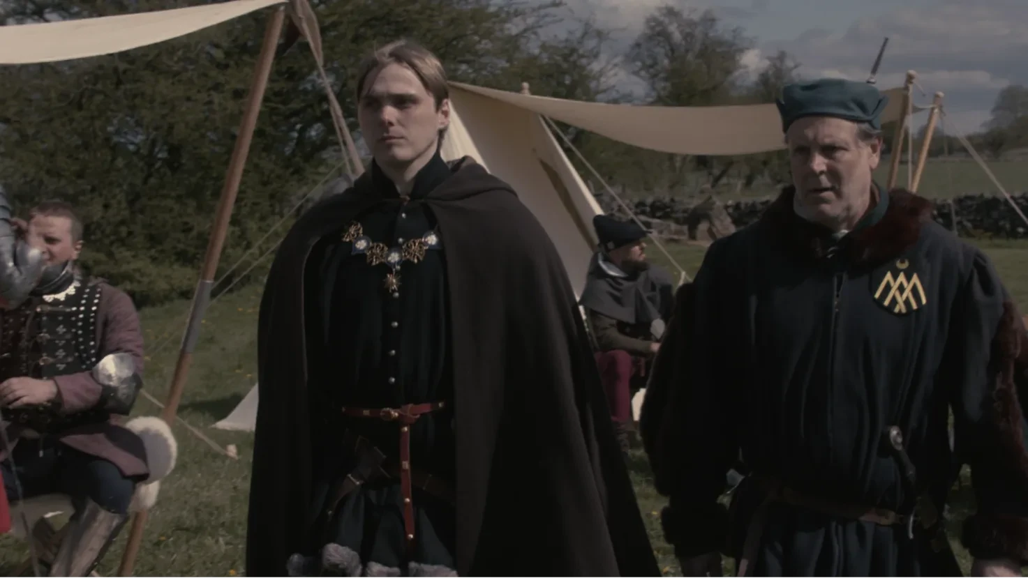 Prince Richard and Sir Robert walk through their camp