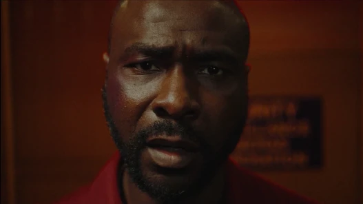 A disturbed looking man stares straight into the camera
