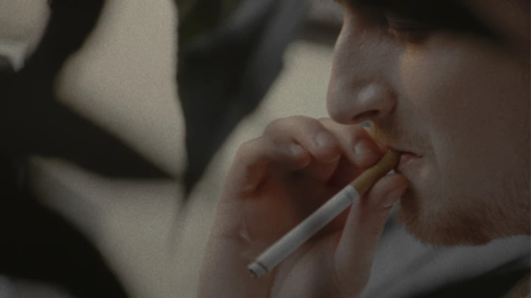 Kenneth, the lead, smoking a cigarette.