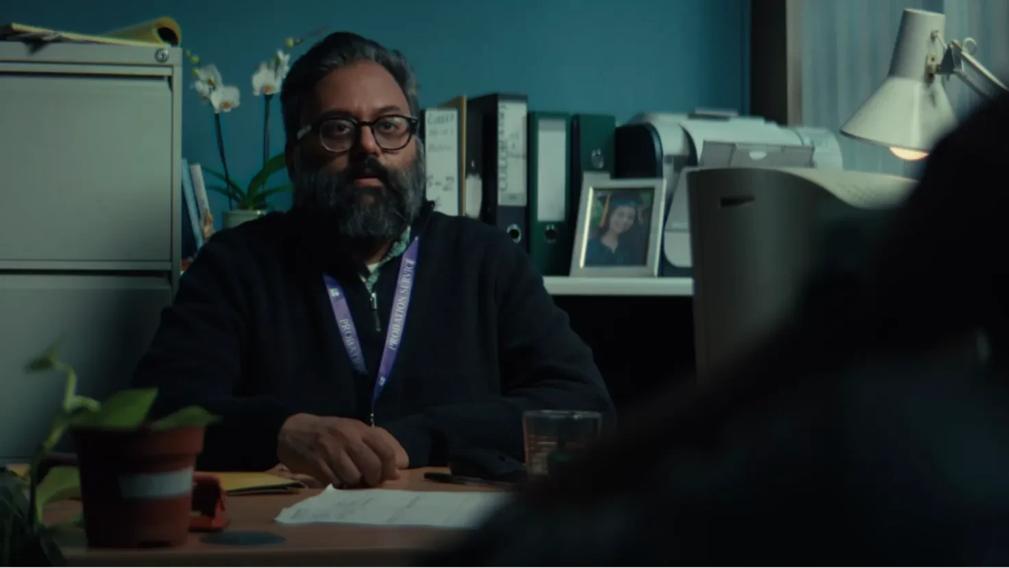 Ravi unimpressed with Jay in his office.
