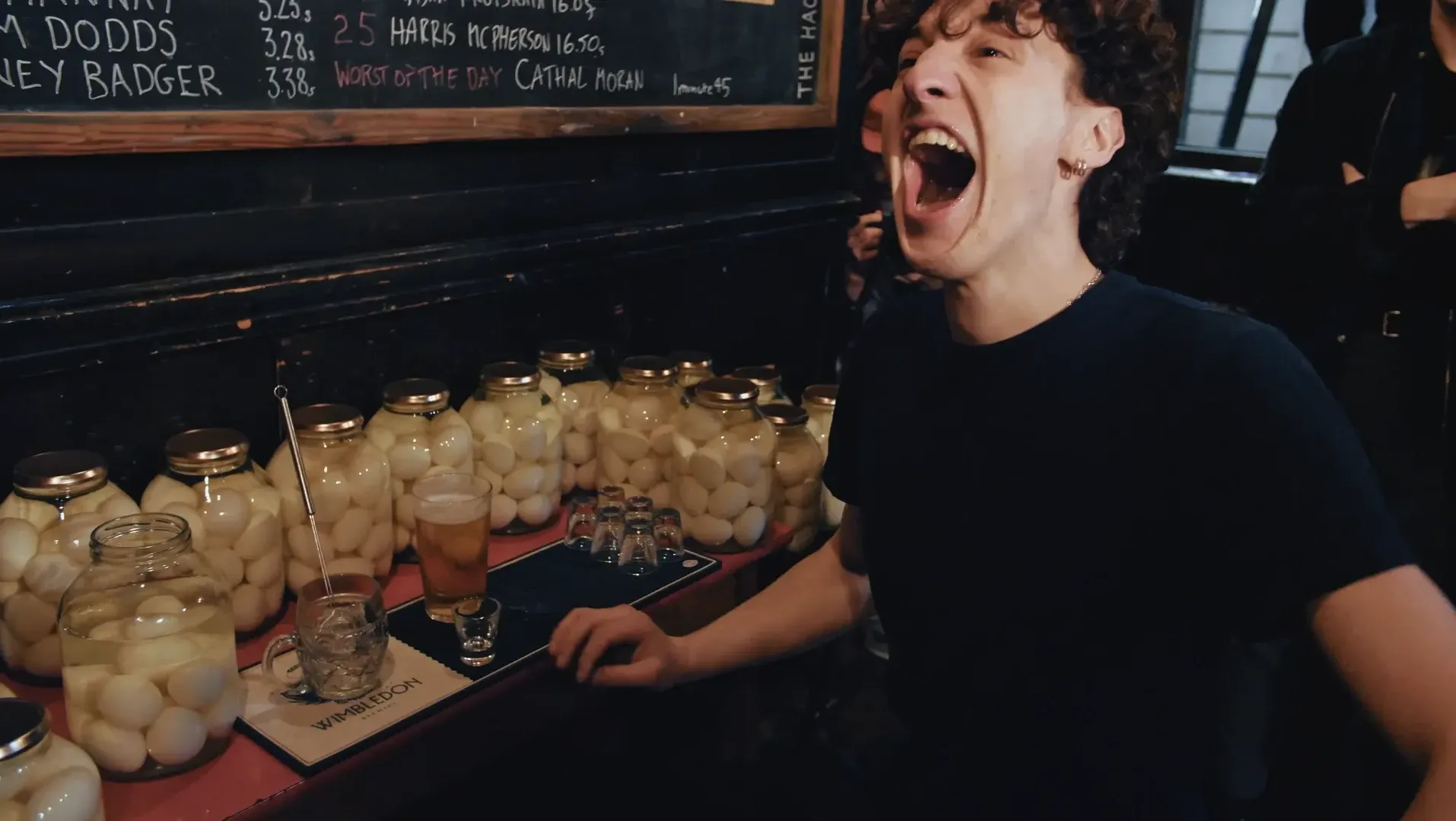 A man shows his open mouth after having eaten a pickled egg