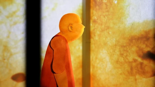 A paper cut-out person looking at a projection of plants silhouettes on a paper wall