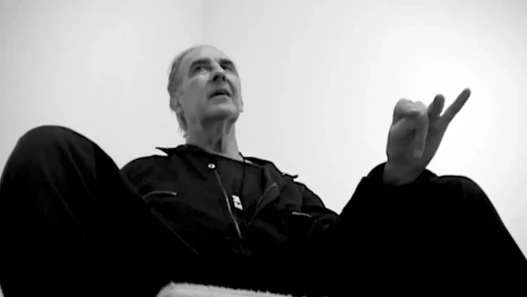 A documentary contributor, David Croland, seen from a low angle, talking about his opinion on the evolution of the New York art scene