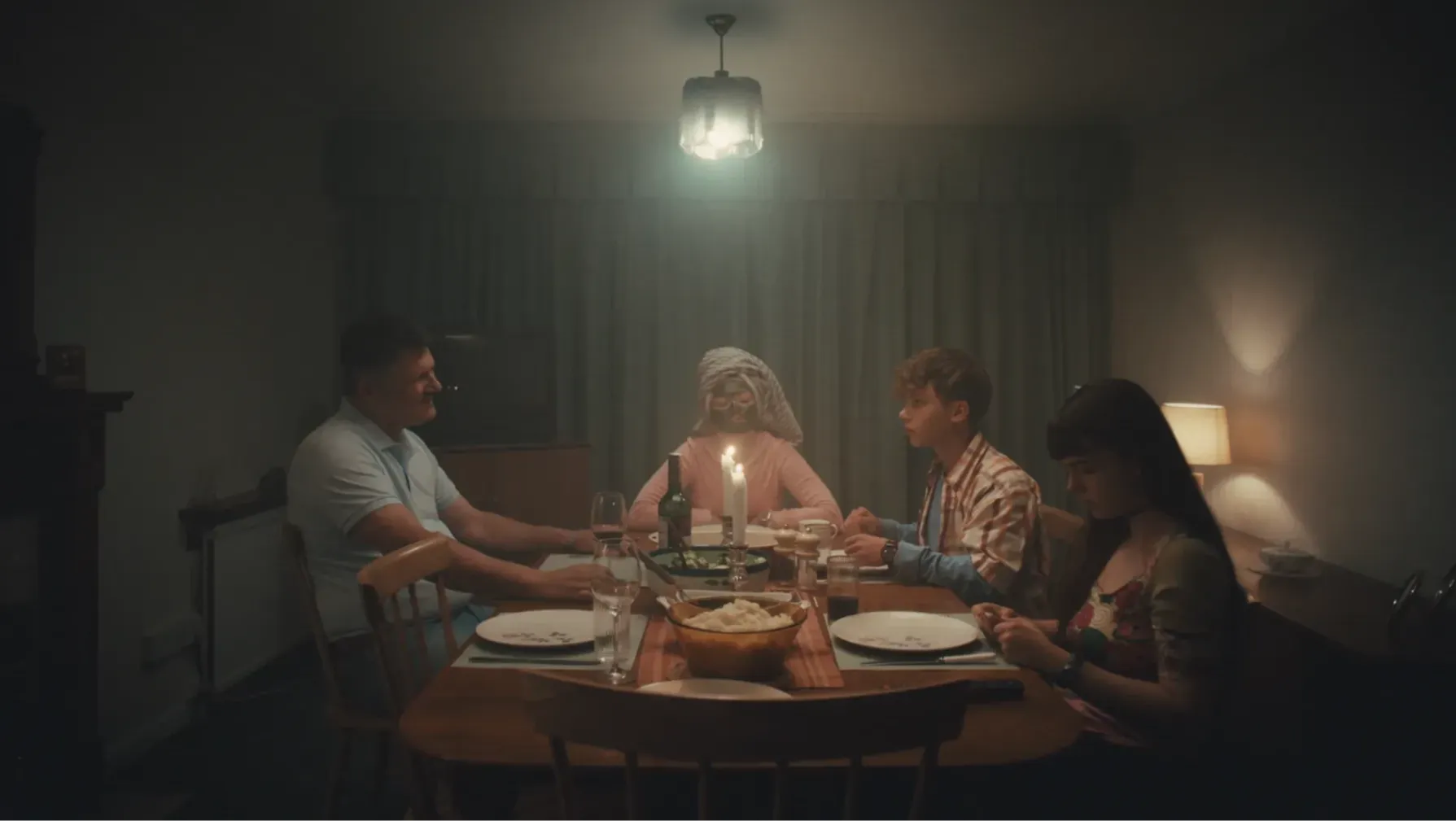 A family sit around the dinner table