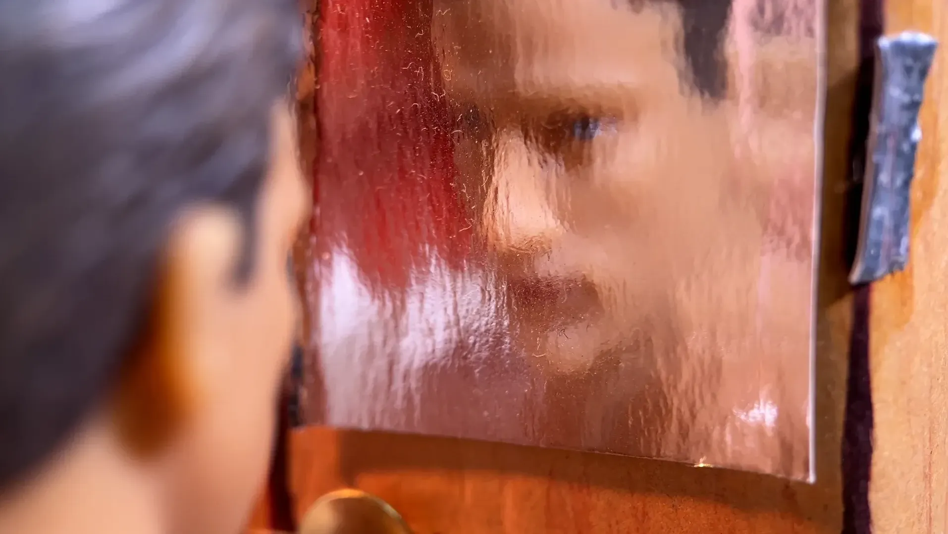 An action figure looks in the mirror