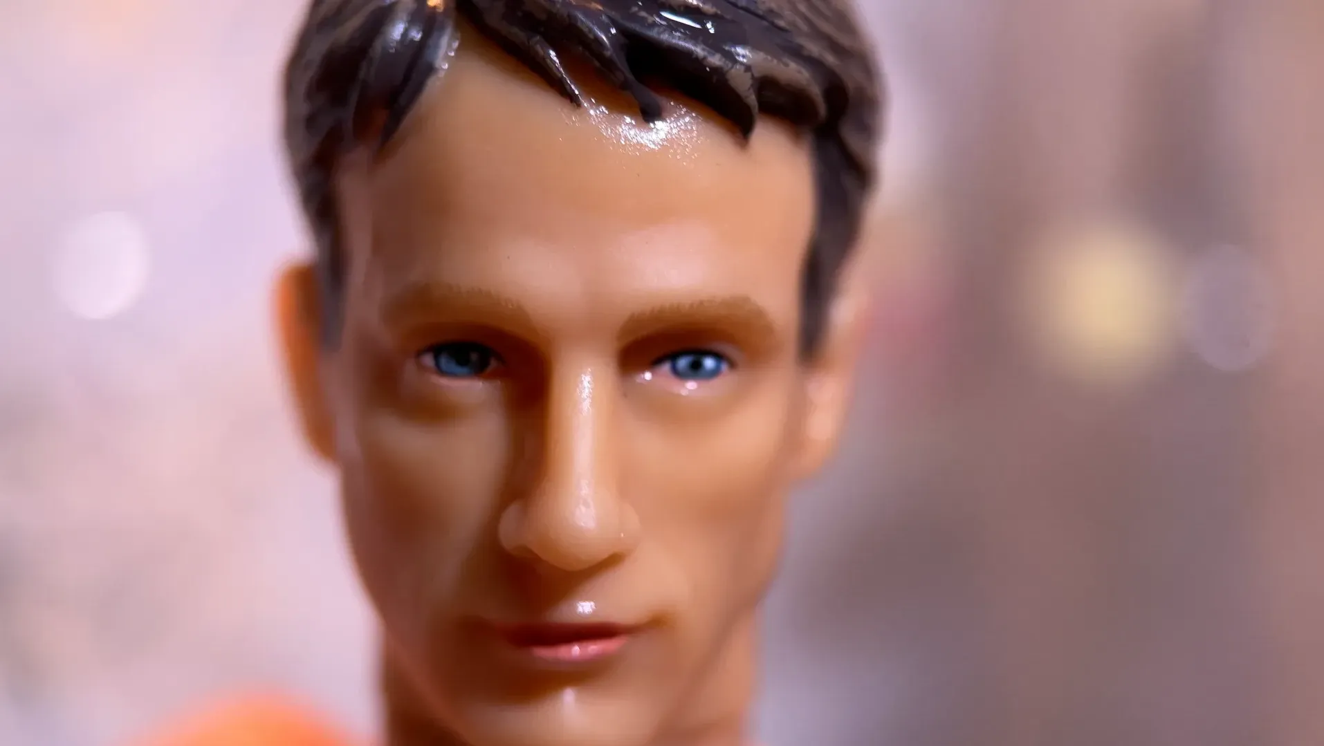 A close up of an action figure face with blurred background