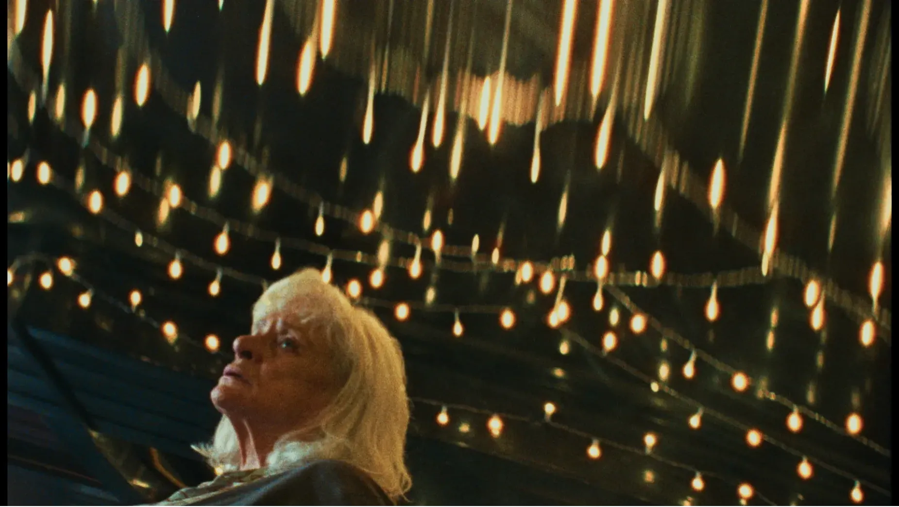 A woman in her 70s surrounded by distorted lights