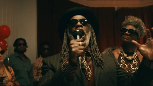 A man in sunglasses praying at a wedding.