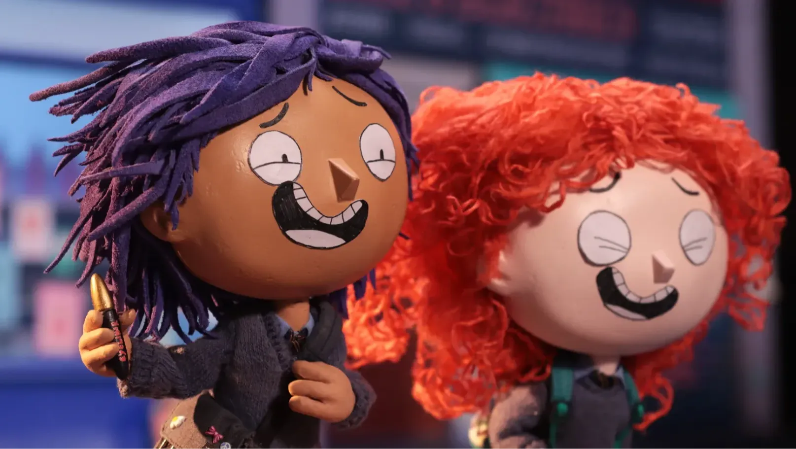 Two schoolchildren running. One of them has a piece of eyeliner in their hand.