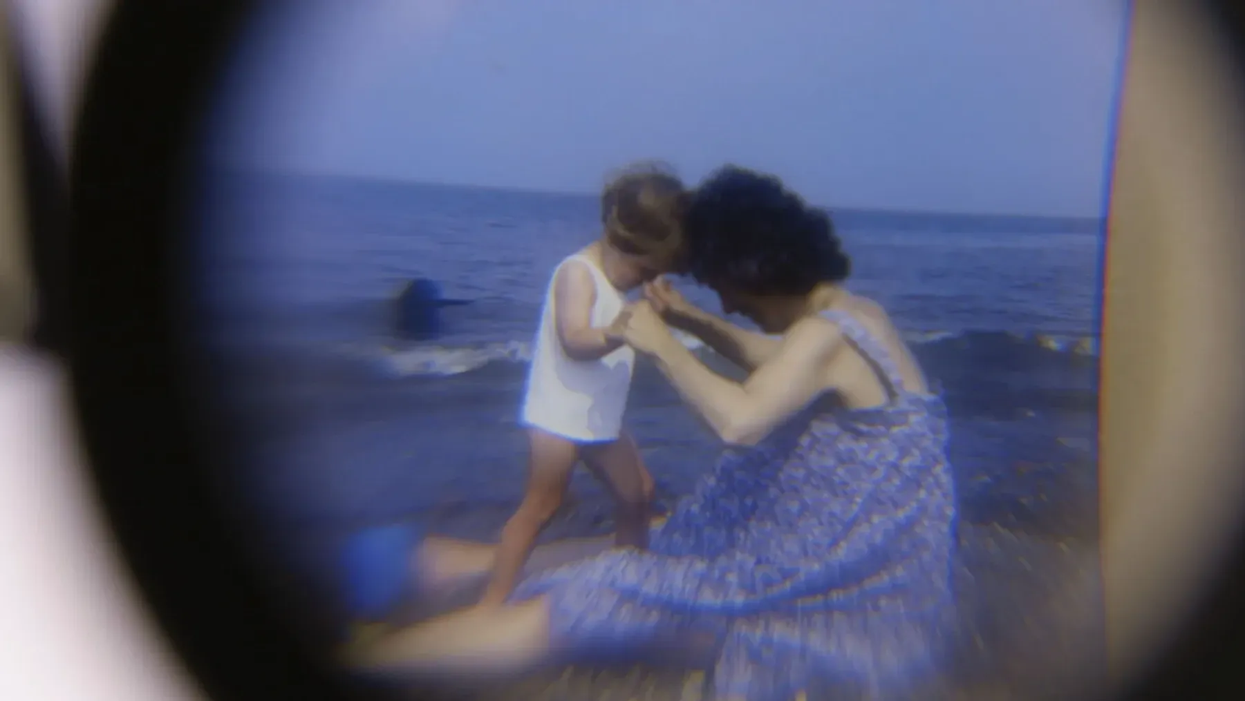 The film's director (Eamon) and his mother (Sue) in a slide photograph, filmed through a loupe