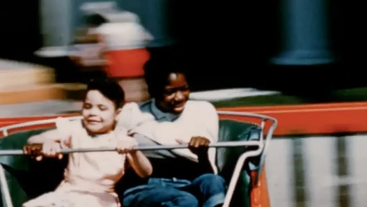 Two young people on a carnival ride.