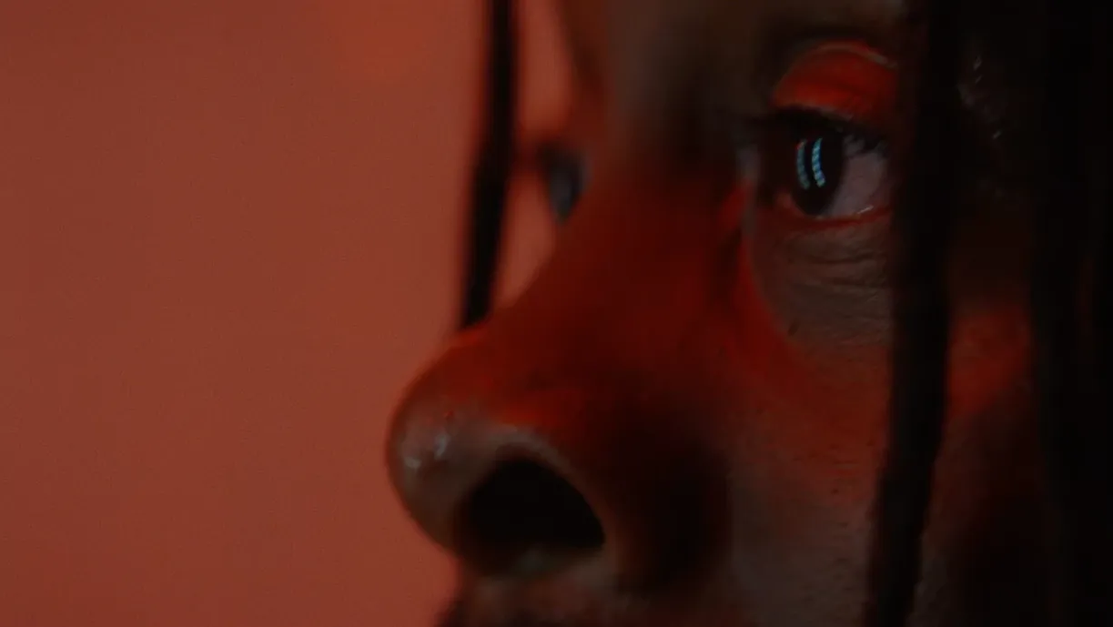 A man stares offscreen into a mirror