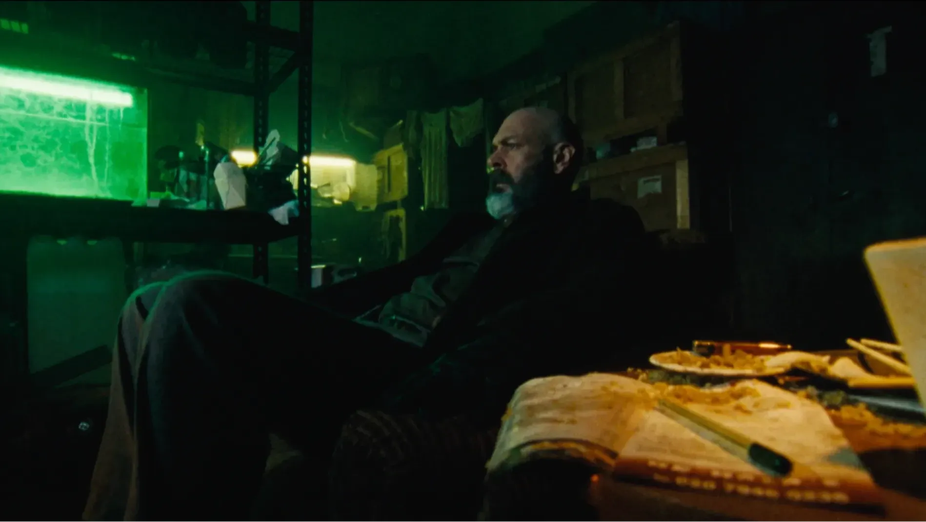 A detective sitting in a grotty apartment.