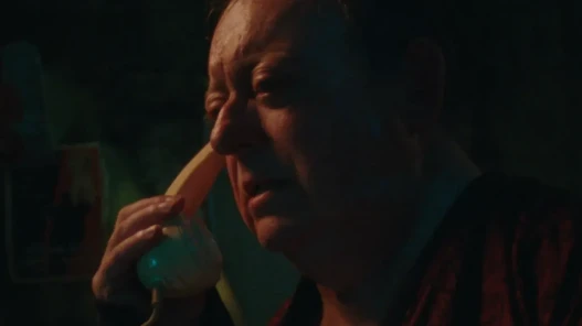 A man holds a phone to his ear