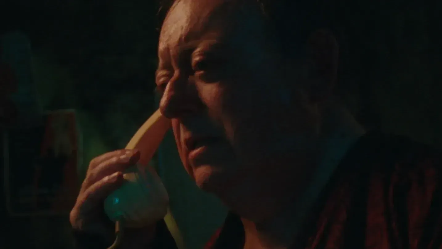 A man holds a phone to his ear