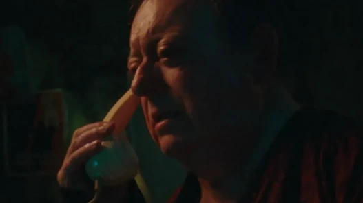 A man holds a phone to his ear