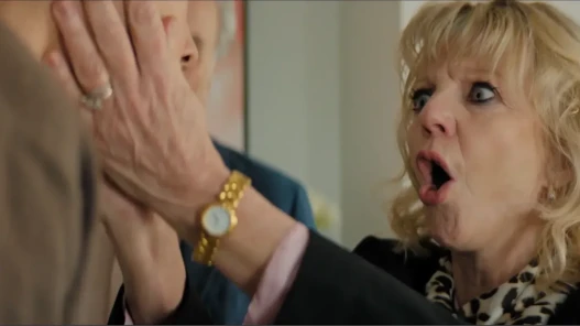 A woman in shock holding man's face