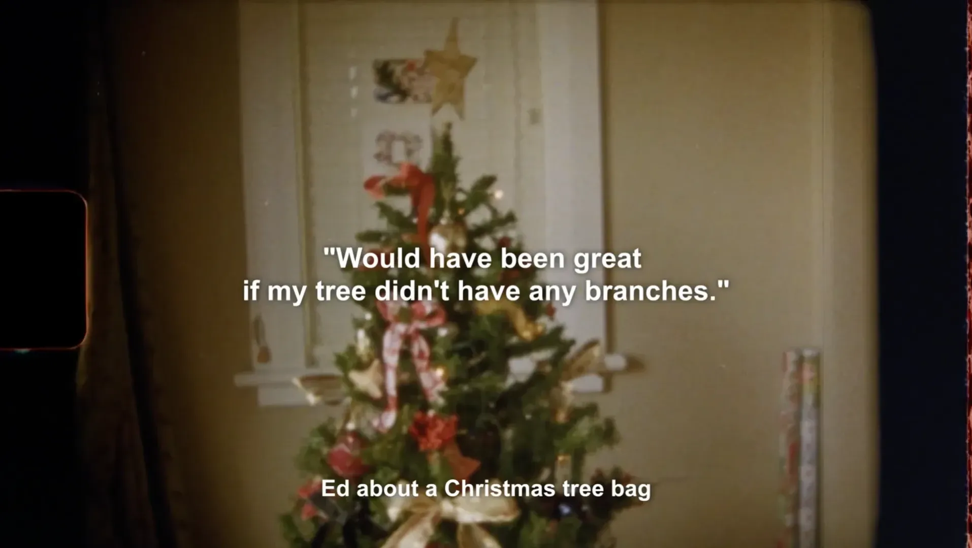A super 8 image of a christmas tree. Text says "Would have been great if my tree didn't have any branches.' - Ed about a Christmas tree bag.