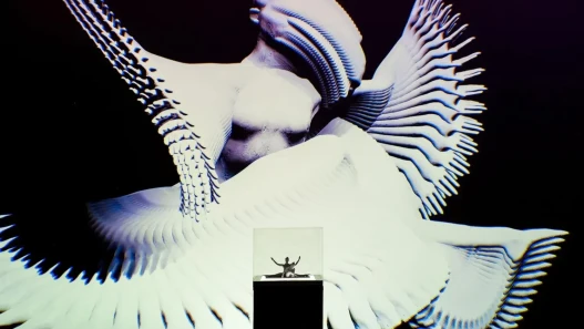 A 3d printed of a female duet displayed in a vitrine in front of a projection of a digital image of the split second of the duet captured in photogrametry