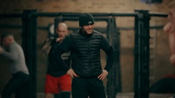 MMA coach coaching inside gym