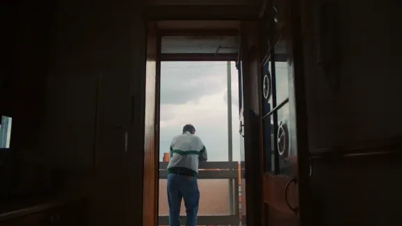 A man standing in the doorway looking out