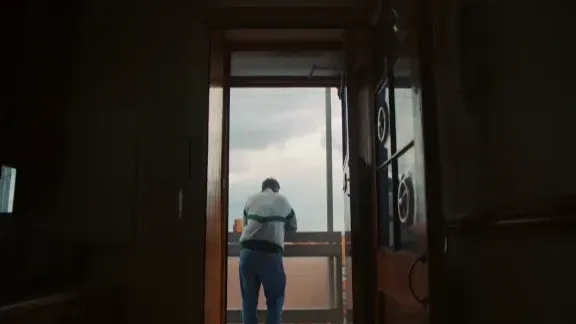A man standing in the doorway looking out