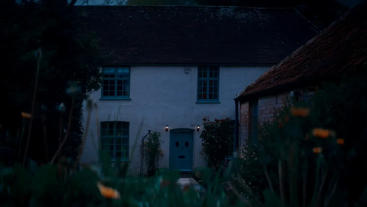 A spooky family home looms at dusk