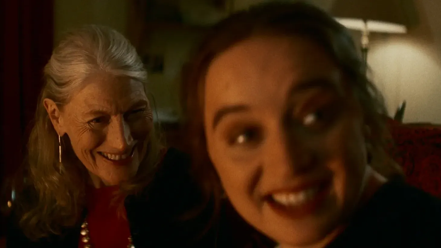 Two women sit together smiling