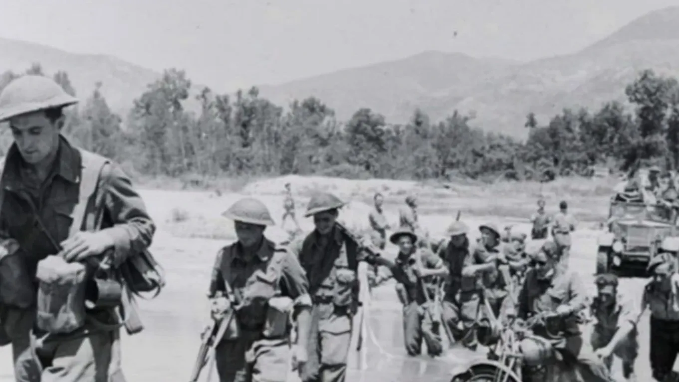 Black and white image. Soldiers marching.