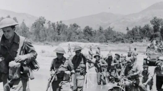 Black and white image. Soldiers marching.