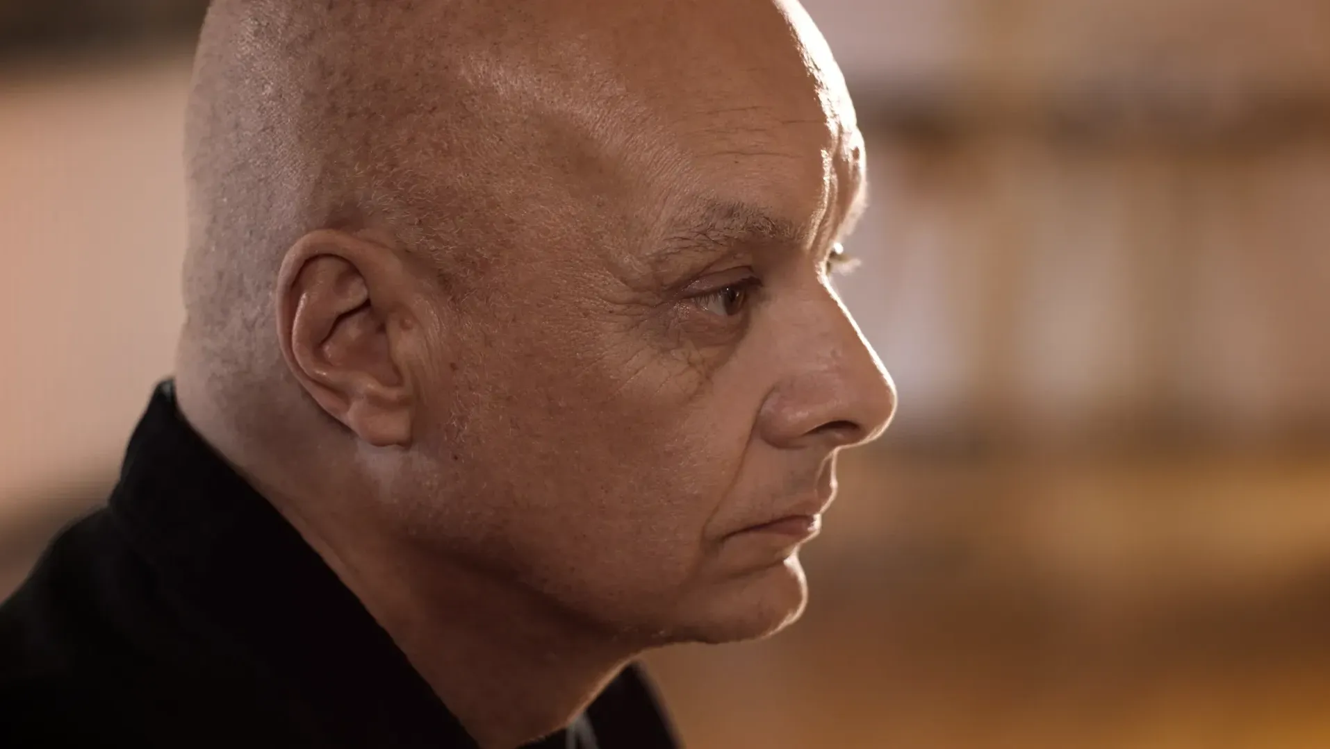 Documentary interview image. Side profile view of a man thinking.