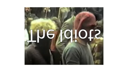 The film's title projected backwards on the image of two characters. 