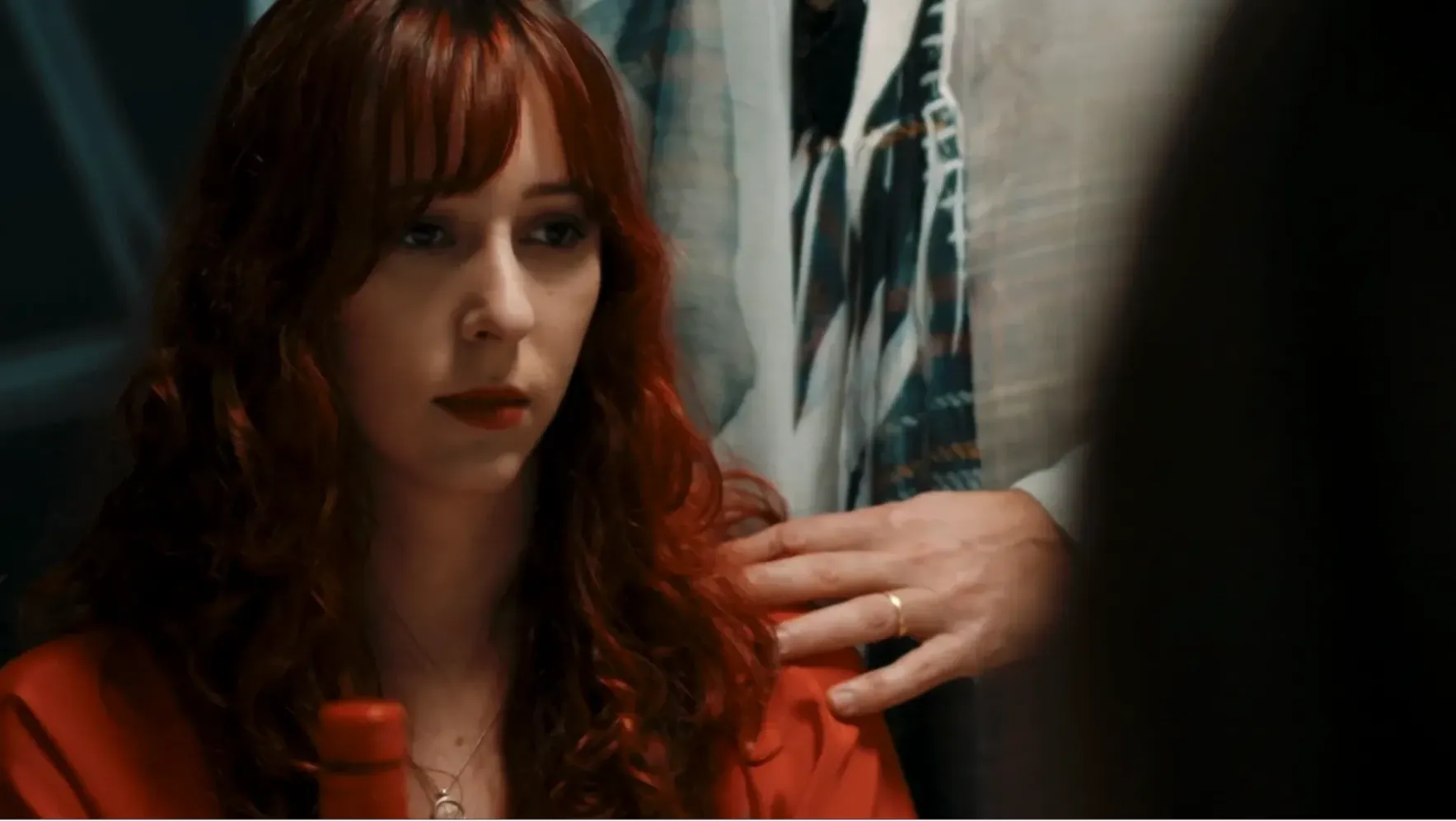 Dinner table scene, psychological control, the wife is subject to a societal trial and judgement influenced by her abusive husband.