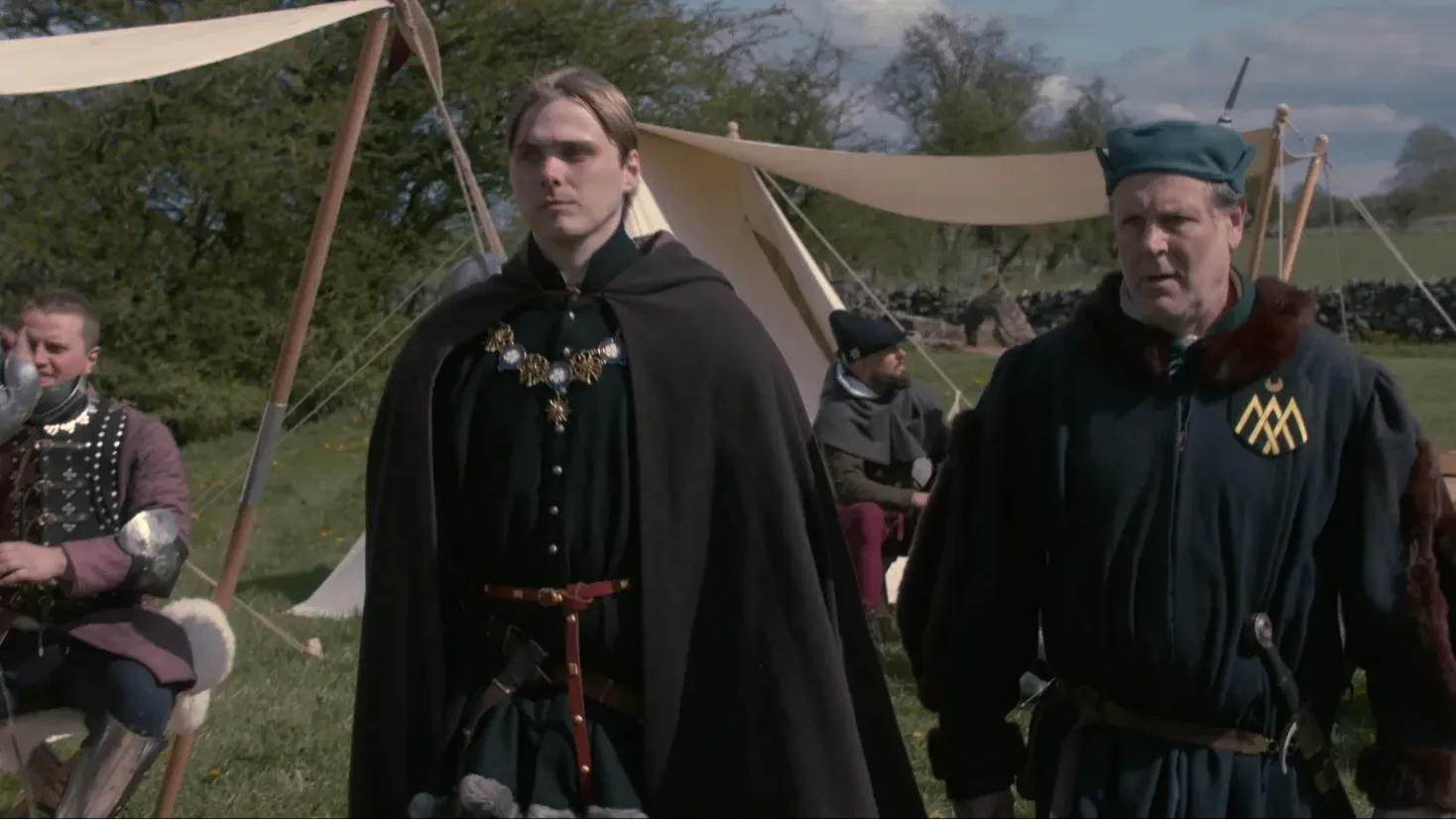 Prince Richard and Sir Robert walk through their camp