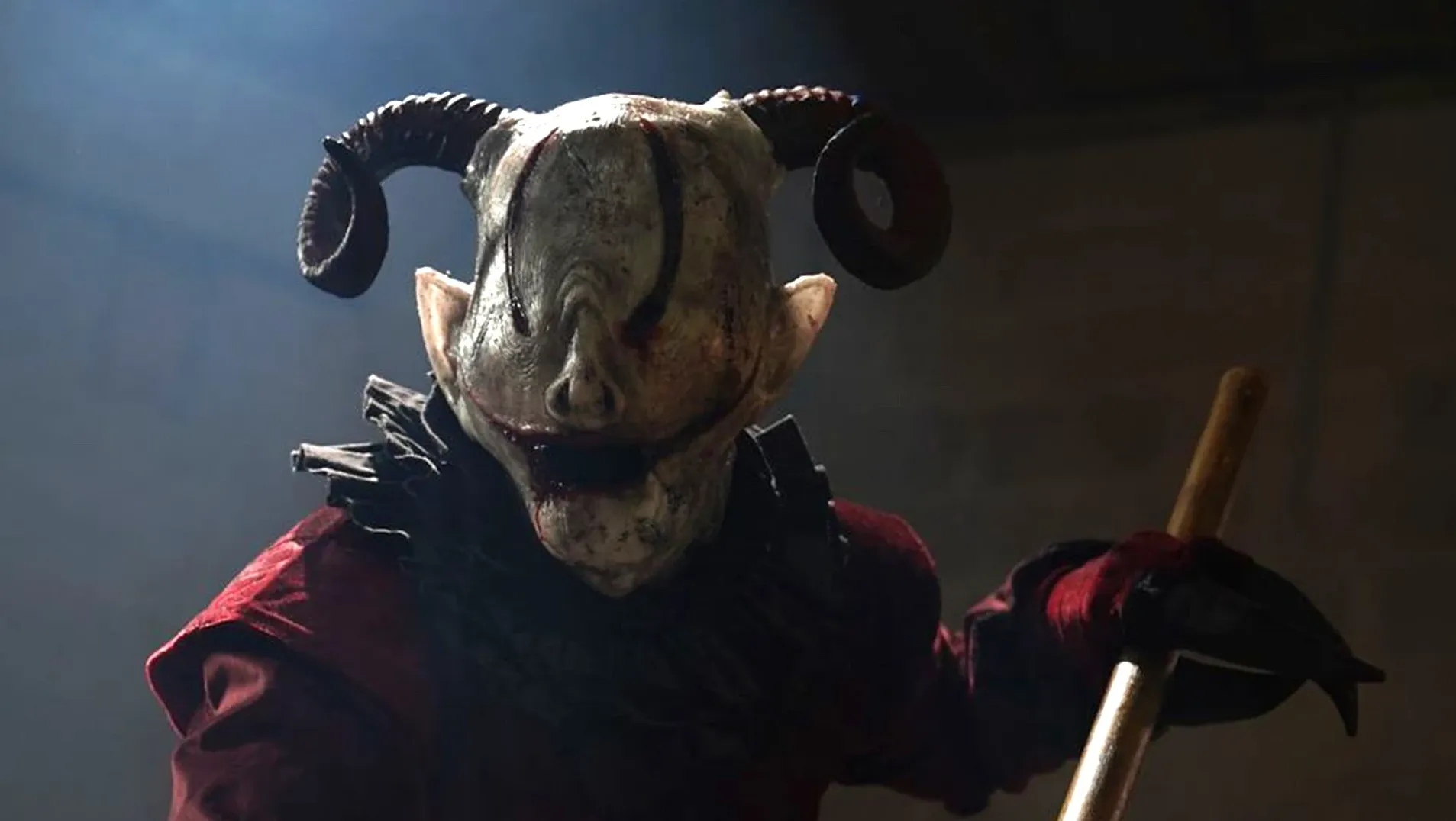 A demon wearing a mask carrying an axe attacks.