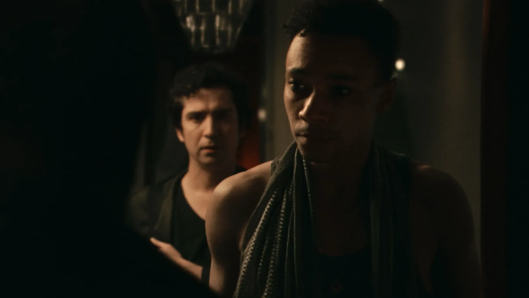 Ted opening the door to someone and Andy standing behind him.