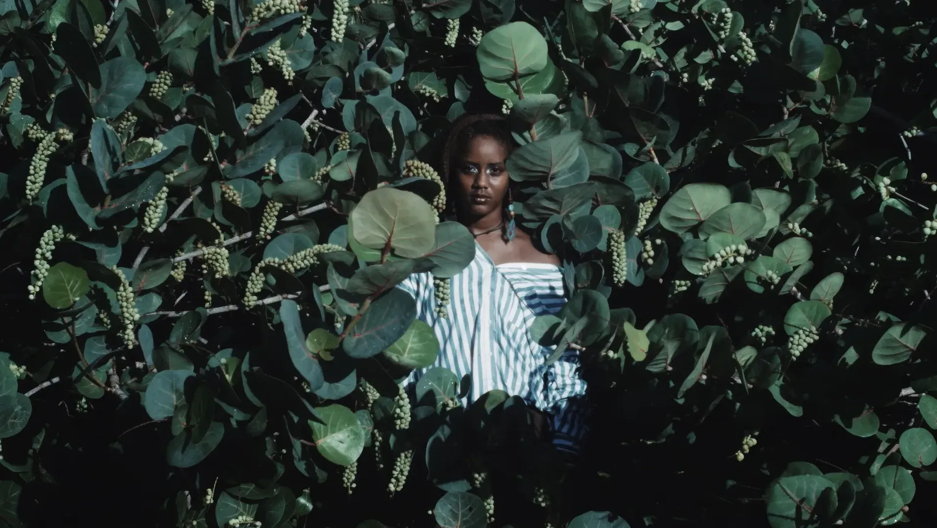 Woman in Grape Bay tress in stripped shirt and dangling earring