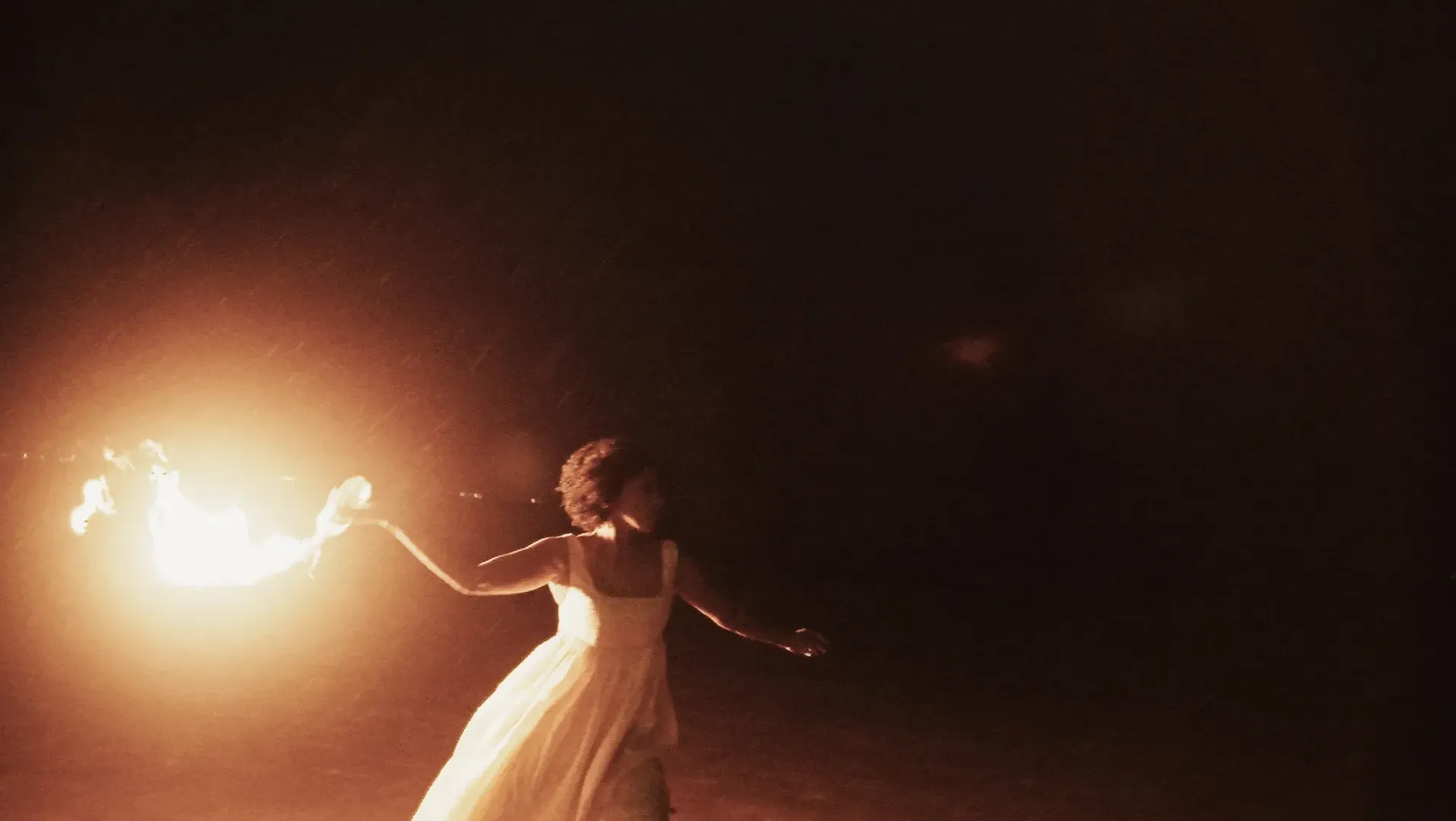 Woman in yellow formal dress throws molotov cocktail