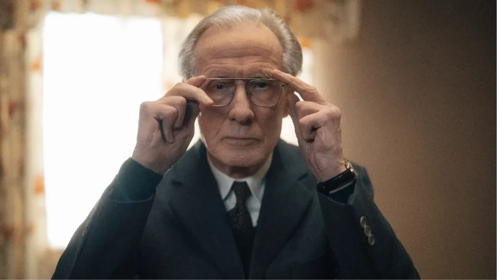 Bill Nighy adjusting his glasses, close-up