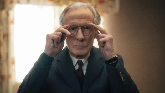 Bill Nighy adjusting his glasses, close-up