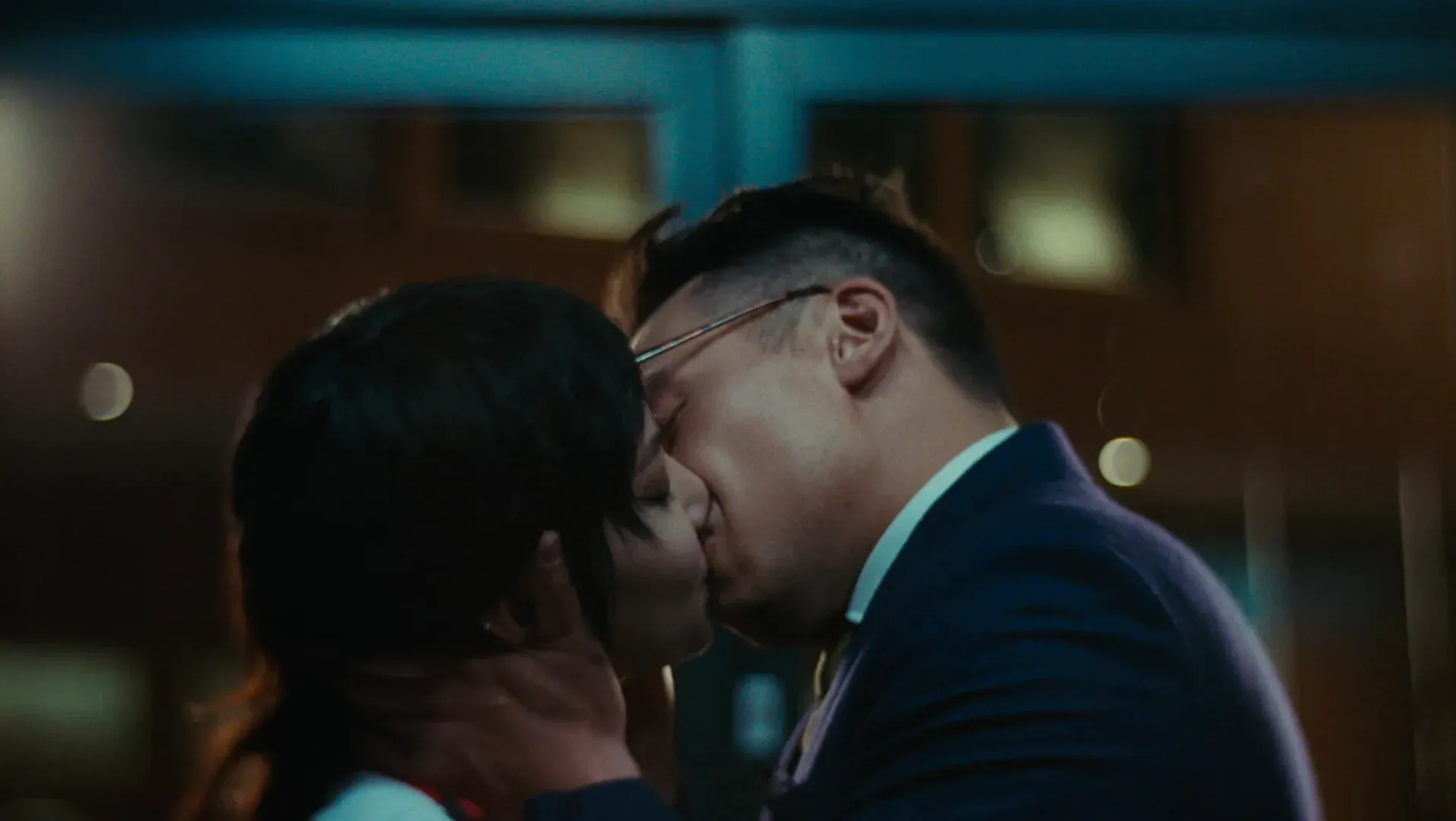 A couple share a close, tender kiss
