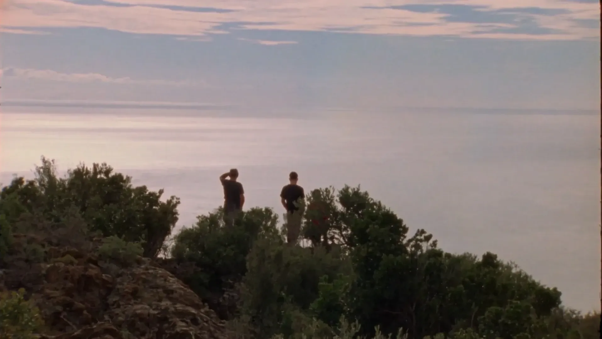 An image of a men looking out over the sea